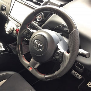 REAL ORIGINAL SERIES EMBLEM TYPE D SHAPE BLACK CARBON RED X BLACK EURO STITCH STEERING WHEEL FOR TOYOTA GR86 ZN8  GRM-BKC-RD